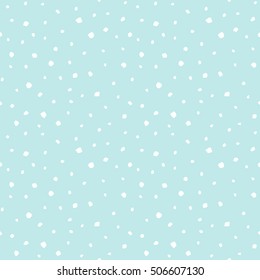 Winter abstract background. Falling snow flakes, uneven specks, spots, blobs, splashes seamless pattern. Free hand drawn speckles, flecks of different size texture. Light pastel colors.