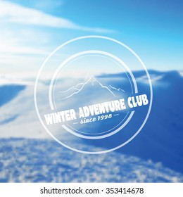 Winter Adventure Club banner with mountain sketch. Logo on a blurry mountain background. Vector illustration.