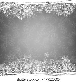 Winter background. Borders made of fluffy snowflakes on soft gray background with space for text.