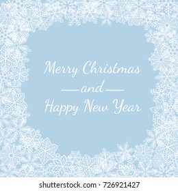 Winter background. Frame made of fluffy snowflakes with text on blue background with falling snow.