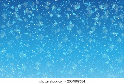 Winter background with snowfall on blue background.