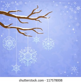 Winter background with snowflakes hanging on a tree