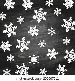 winter background with snowflakes on a blackboard chalk