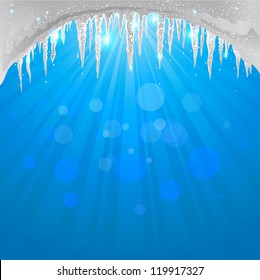 Winter background with sparkling icicles with space for text