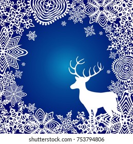 Winterblauer Hintergrund mit Papier, das Schneeflocken und Hirsch ausgeschnitten hat