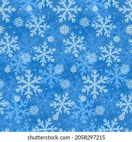 Fondo azul invernal con copos de nieve. Patrón veloz.