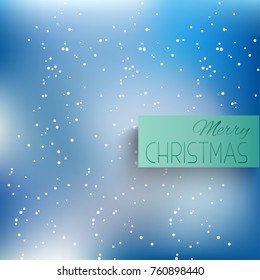 Winter blurred the background with the falling snow. Fall of snow, snowflake on blue sky. Celebratory winter background for Christmas and New year. Falling snow background. Snowfall background.