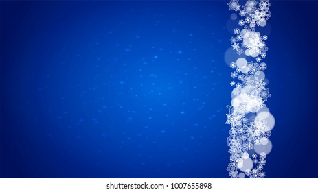 Winter border with white snowflakes for Christmas and New Year celebration. Horizontal winter border on blue background for banners, gift coupon, voucher, ads, party events. Falling frosty snowflakes.