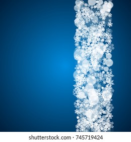 Winter border with white snowflakes for Christmas and New Year celebration. Holiday winter border on blue background for banners, gift coupons, vouchers, ads, party events. Falling frosty snowflakes.