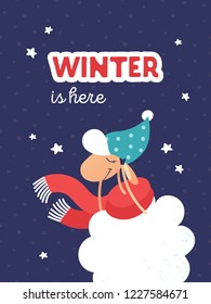 Winter card with cute sheep in red scarf putting on hat. Greeting banner for winter holidays (Christmas, New Year) with snowflakes, stars and text "Winter is here". Illustration with lamb