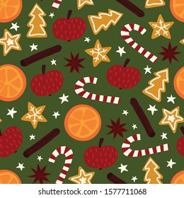 Winter Christmas spices seamless vector pattern. Repeating background of star anise, apple, orange, cinnamon rolls, cookies, candy canes. Hand drawn isolated objects on green background. 