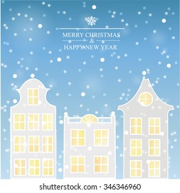 Winter city. Snow falls on building. Sky with snowflakes.
