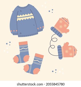 Winter clothes. Jumper, mittens, gloves, socks in blue and beige