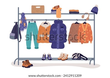 Winter clothes on racks. Fashion warm apparel on hanger. Wardrobe storage. Clothing assortment rail. Secondhand casual garments. Coats at shelving. Hats and boots. Garish