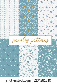 Winter collection of 6 blue and white seamless patterns for wrapping paper. Patterns with snowflakes, fir, bead garland, oranges and silhouettes of plants
