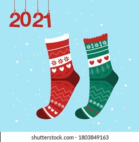 Winter collection of knitted socks, warm woolen Scandinavian elven knee-highs. Happy New Year 2021 and Christmas card.The numbers hang on ribbons,snowflakes around.Children's accessory, promo sale