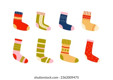 Winter colorful socks and stockings. Knitted foot wear. Cold season essentials. Christmas time, New Year. Retro vintage colors.