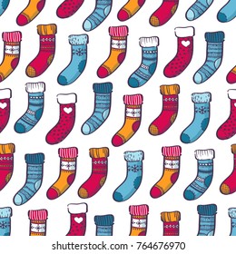 Winter colorful warm socks hanndrawn doodle seamless pattern. Cozy knitted socks pattern. New Year design, festive decorations. 