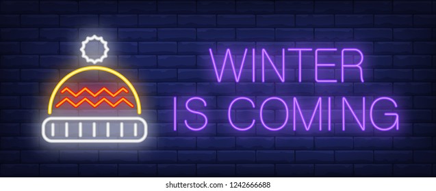 Winter is coming neon text with knitted hat. Christmas advertisement design. Night bright neon sign, colorful billboard, light banner. Vector illustration in neon style.