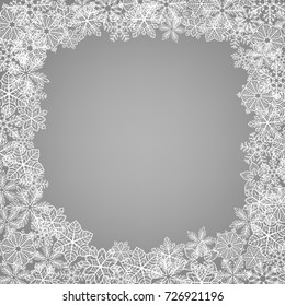 Winter frame Frame made of fluffy snowflakes on soft gray background with falling snow.
