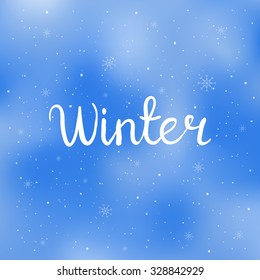 Winter. Hand written calligraphic word. Isolated typographical design element for prints, invitations, templates, cards. Unique typography on blurred background.