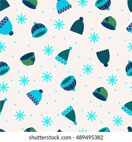 Winter hats seamless vector pattern in blue colors. Colored bonnets and headers and snowflakes. Xmas time pattern. 