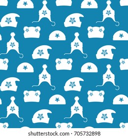 Winter hats silhouettes with snowflakes seamless pattern. Vector winter clothes seamless texture
