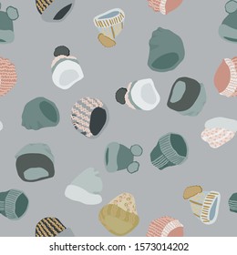 Winter head wear Knitted beanies and hats seamless pattern on grey background. Web, wrapping paper, textile, wallpaper design, background fill.