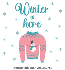 Winter is here lettering composition and warm knitted sweater with snowman. Christmas clothes and snowflakes. 