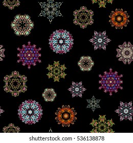 Winter Holiday Knitted Pattern with orange, beige and neutral Circles, Dots and Snowflakes On a Black Background. Seamless vector background.