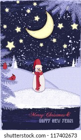 Winter Holidays Greeting Card - Snowman in a dreamy, snowed-in landscape at night, with stars, moon, snowy hills, pine trees and cardinals; copyspace for Christmas and New Year's greetings