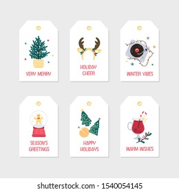 Winter holidays labels with pine tree, christmas music and drinks, snow globe and ornaments. Vector set of hand-drawn christmas elements with sample typography.