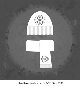Winter icon, warm scarf and hat on gray vintage background . Minimalism. Icon Logo
