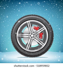 The winter inflated tire on blue snowy background. Wheel in the snow