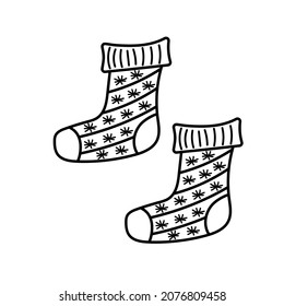 Winter knitted socks in doodle style. Warm and cozy hygge clothing with snowflakes.