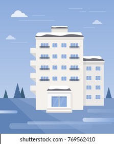 Winter landscape with apartment building.