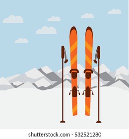 Winter landscape with mountain background, blue sky, ski and sticks