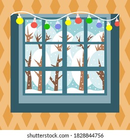 Winter landscape outside the window is snowing, snowy trees, snowdrifts. Christmas time. Colorful garland on the window