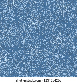 Winter light blue background filled with white snowflakes