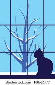 Winter lonely cat and a tree outside the window