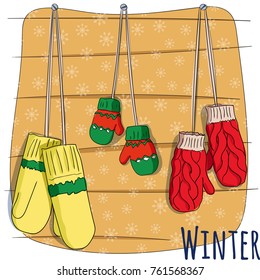 Winter mittens on rope. Vector illustration for a postcard or a poster, print for clothes. New Year's and Christmas. Festive postcard.