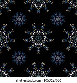 Winter mood background. Winter weather. Abstract snowstorm with blue and yellow snowflakes. Blow snow texture pattern on black background. Winter windstorm. Seamless pattern with snowflakes.