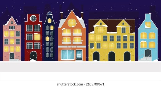 Winter nordic houses on a snowy night with a burning light in the windows.