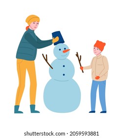 Winter outdoor games. Happy mother and son build