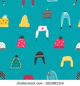 Winter pattern with knitted hats. Hand drawn seamless pattern. Winter background.