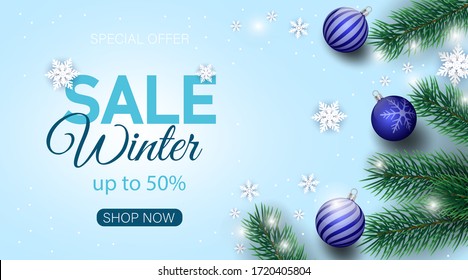 Winter sale banner decorated with Christmas tree branches and snow.