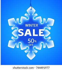 Winter Sale discount tag on blue background. Vector blue snowflake. Holiday decoration