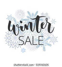 Winter sale hand written inscription with blue snowflakes on white background