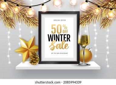 Winter sale poster with christmas holiday decorations. Chrisrmas background with string of lights. 3D interior design with black frame on white walll shelf.