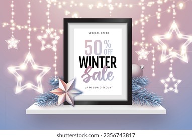 Winter sale poster with christmas holiday decorations. Chrisrmas background with string of lights. 3D interior design with black frame on white walll shelf.
